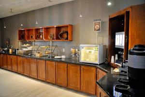 a large kitchen with a counter with a microwave at SpringHill Suites Houston Katy Mills in Katy