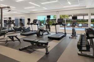 a gym with several treadmills and cardio machines at Courtyard by Marriott San Jose Airport Alajuela in Alajuela City