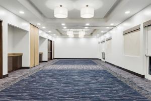 an empty hallway in a building with a carpet at Courtyard by Marriott San Jose Airport Alajuela in Alajuela City