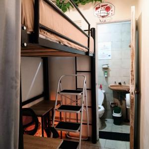 a room with a bunk bed and a sink and a toilet at Kuyay Hostel in Bogotá