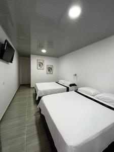 Ένα ή περισσότερα κρεβάτια σε δωμάτιο στο Hotel Plaza Real Oiba