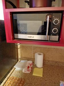 a microwave on top of a counter with some food at A 5-star hotel room in front of Mansoura University in Mansoura