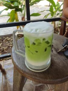 a drink in a glass sitting on a table at Erawan Guesthouse in Pakse