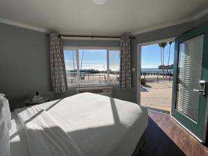 a bedroom with a bed and a view of the ocean at Casablanca Inn on The Beach in Santa Cruz