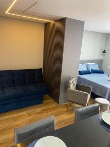 uma sala de estar com um sofá e uma cama em Apartamento Flat Palladium em São Vicente