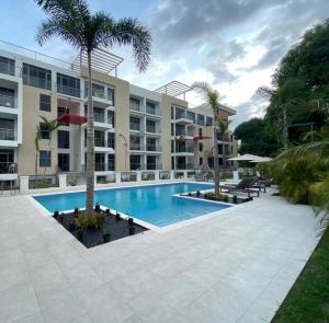 a swimming pool in front of a building at The Echelon Suite in Kingston