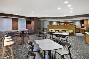 a restaurant with tables and chairs and a bar at SpringHill Suites Minneapolis-St. Paul Airport/Eagan in Eagan