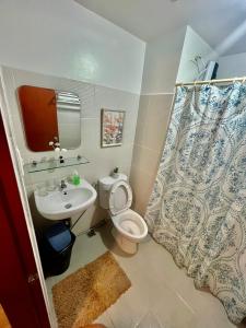 a bathroom with a toilet and a sink at Mesavirre Garden Residence in Bacolod