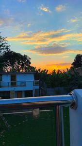 a view of a sunset with a building and trees at Golden hour tiny house in Arusha