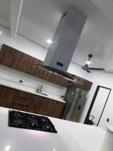 a kitchen with white counters and a stove top oven at Finca para estrenar in Anapoima +11 photos