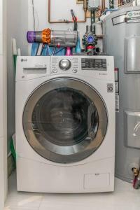 a washing machine in a laundry room with aitivity at Luxurious Soho Apartment~ 2 Bedroom 2 Bathroom in New York