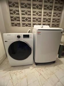 a washing machine and a microwave sitting on a floor at Paradise Vista in Bamboo Market