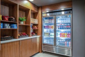 a refrigerator filled with lots of drinks in a kitchen at Holiday Inn Express Portland SE - Clackamas Area, an IHG Hotel in Gladstone