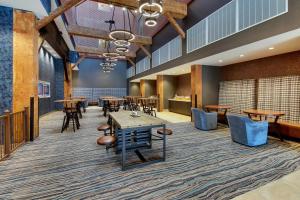 a dining area with tables and chairs in a room at SpringHill Suites by Marriott Montgomery Downtown in Montgomery