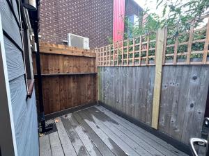 a backyard with a wooden fence and a gate at Central London Zone 1 apartment in London