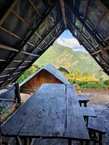 a picnic table in a tent with a view of a mountain at Eco Lodge Haputale-Camping Sri lanka in Haputale