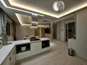 a living room with a kitchen and a dining room at IMSTAY friendly child Eoeum Aewol in Jeju