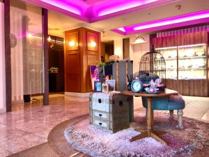 a lobby with a table with a bird cage on it at Canon Himeji Higashi (Adult Only) in Himeji