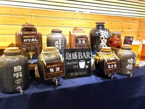 a table with jars of honey on a blue table at Hotel Art Stay Naha Kokusai-Dori in Naha