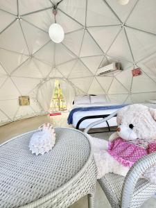 een teddybeer op een tafel in een yurt bij Eco Glamping Treehouses Closest Resort To All Tourist Attractions in Balilihan