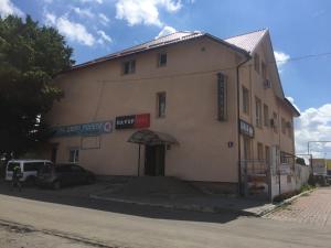 a building with a car parked in front of it at Power House Hotel in Lutsk