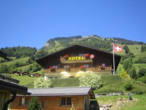 a large building with a flag on top of it at Hotel Elite B&B in Rossinière