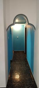 a hallway with a blue door and a tile floor at Dino Enjoy Property in Trincomalee