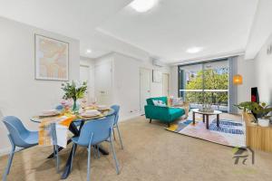 a dining room with a table and blue chairs at Wonderful Home in Your Heart in Waitara