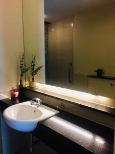 a bathroom with a sink and a large mirror at Deluxe Swiss Garden Residences Bukit Bintang City Center in Kuala Lumpur