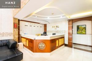 a lobby of a dermatologist office with a reception counter at HANZ Queen Airport Hotel in Ho Chi Minh City