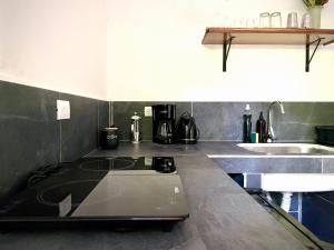 a kitchen with a laptop sitting on the counter at Casa Eden - Modern Peaceful Jungle Apartments in Cocles +101 photos