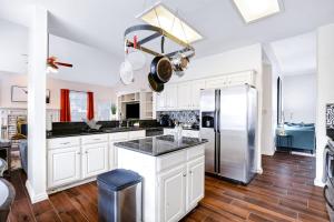 a kitchen with white cabinets and a stainless steel refrigerator at Nr Sea World Games Wifi Bbq Yard Pet Ok in San Antonio