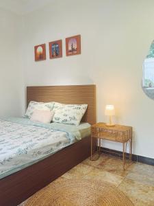 a bedroom with a bed and a table with a lamp at The Nest Homestay in Ho Chi Minh City