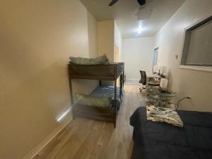 a living room with a couch and a piano at Janis Guest House 6-8 Guests in Wilberforce