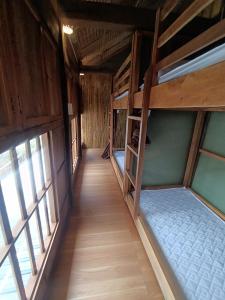 two bunk beds in a room with windows at Ha Giang Wooden House in Ha Giang