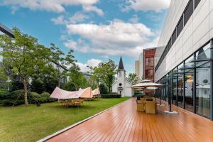a courtyard of a building with a tent and a church at Holiday Inn Wuxi Taihu New City, an IHG Hotel in Wuxi