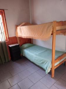 a bedroom with two bunk beds and a window at Banim in El Hoyo