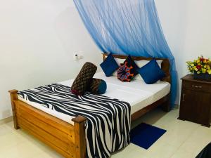 A bed or beds in a room at Priyavimana resort