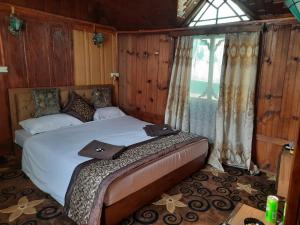 a bedroom with a bed and a window at Hb nancy group of houseboats in Srinagar