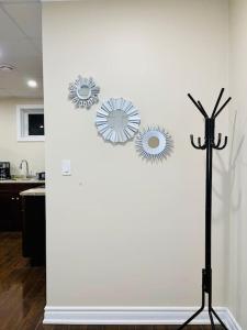 a wall with three flowers on it in a kitchen at Gorgeous Apartment Serene Neighbourhood in Burlington