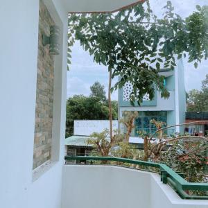 a view from the balcony of a house with a tree at MILAND HOTEL in Can Tho