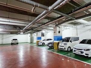 a garage with several cars parked in it at Residence YeoYu Uijeongbu Station in Uijeongbu