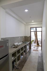 a kitchen with a sink and a tree in the background at Asa Bay Beach Resort in Talpe