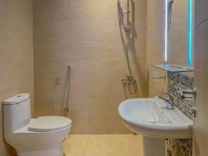 a bathroom with a toilet and a sink at فندق ارجان بارك العزيزية Arjan Park Hotel in Riyadh