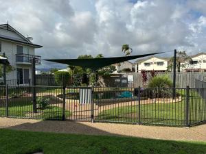 a fence with a green canopy over a yard at Holiday at Henry St West End, Townsville QLD 3 night min in North Ward