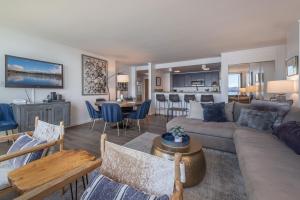 a living room with a couch and a table at Luxurious Lakefront Condo with Lake Views in Brockway Springs Resort Close to Slopes in Kings Beach