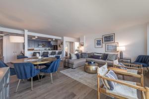 a living room with a couch and a table at VIP Lakefront Condo Amazing Views Pool Pickleball Excellent Location Balcony BBQ in Kings Beach