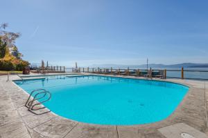 a swimming pool with a view of the water at Luxurious Lakefront Condo with Lake Views in Brockway Springs Resort Close to Slopes in Kings Beach