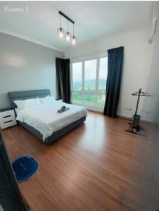 a bedroom with a bed and a large window at Sandakan Ijm pool view condo in Sandakan