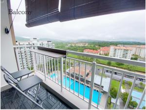 a balcony with a chair and a view of a pool at Sandakan Ijm pool view condo in Sandakan